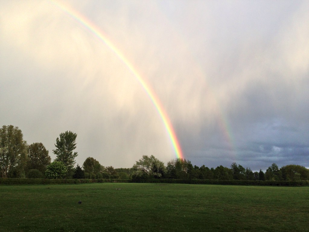 Arcobaleno che sembra fontana che spruzza alto nel cielo